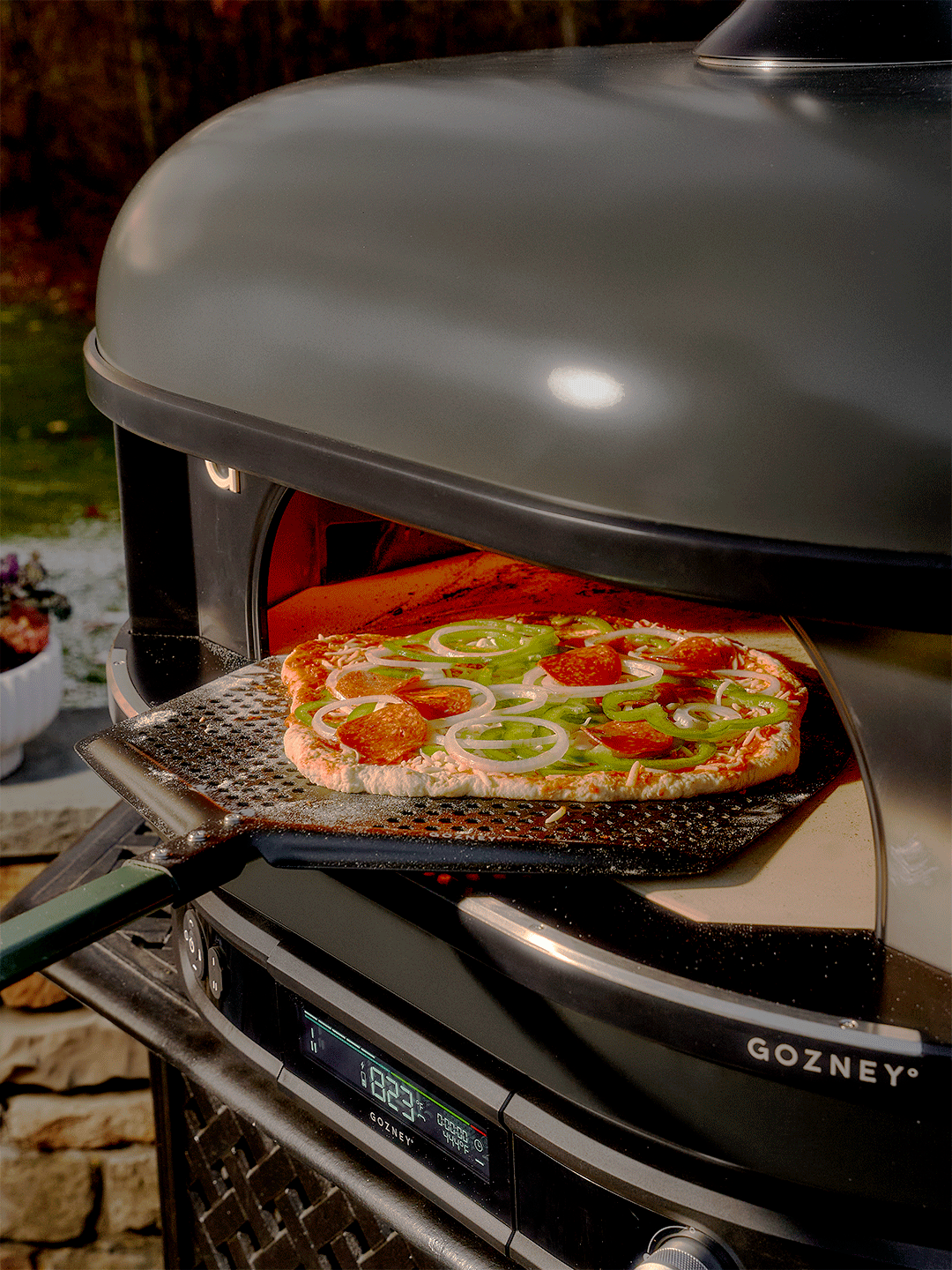 pizza going into pizza oven