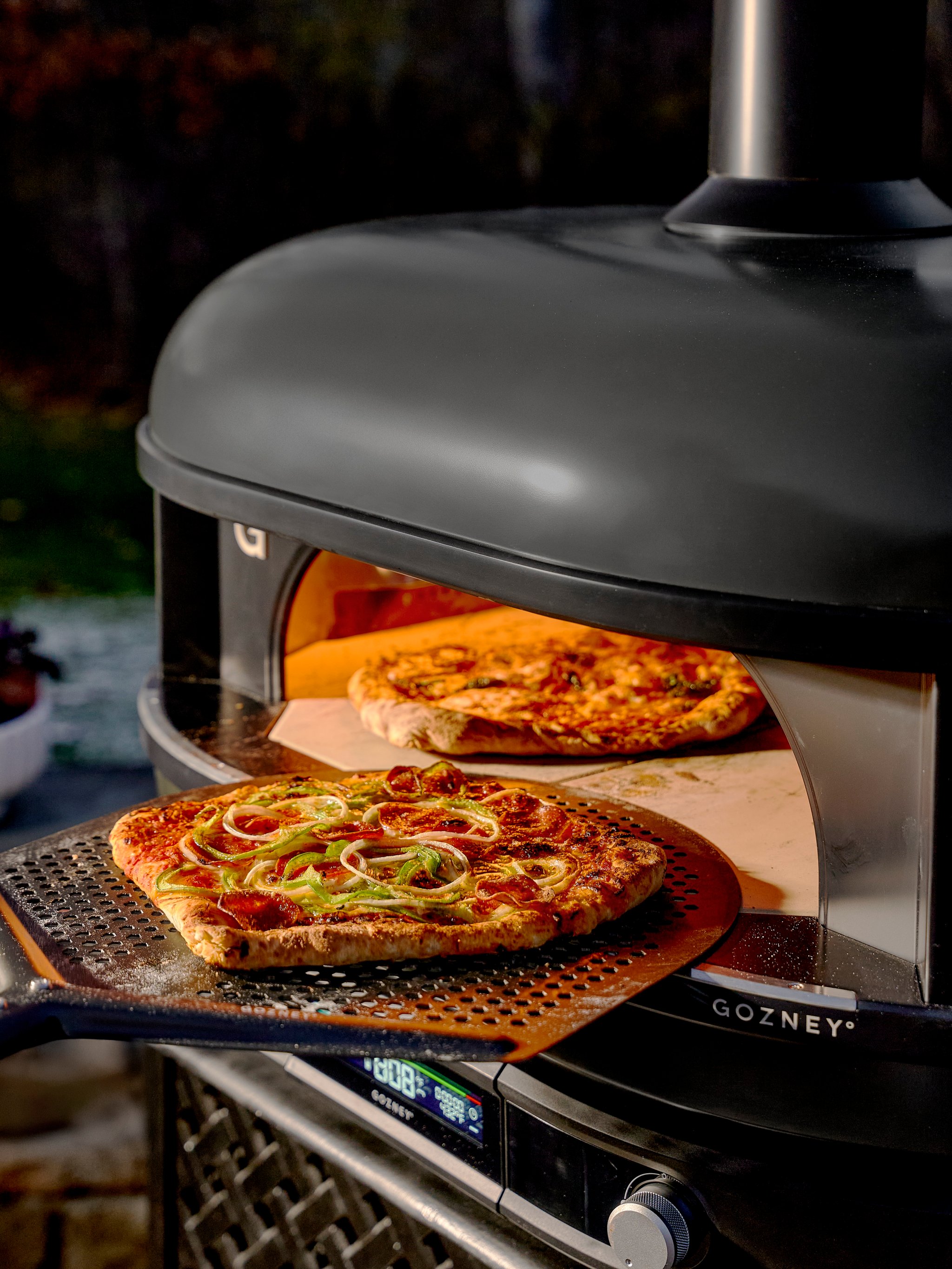 pizza going into pizza oven