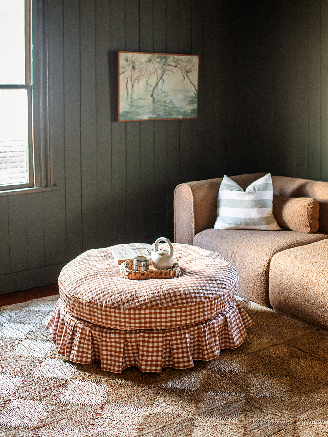 living room with ruffly round gingham ottoman