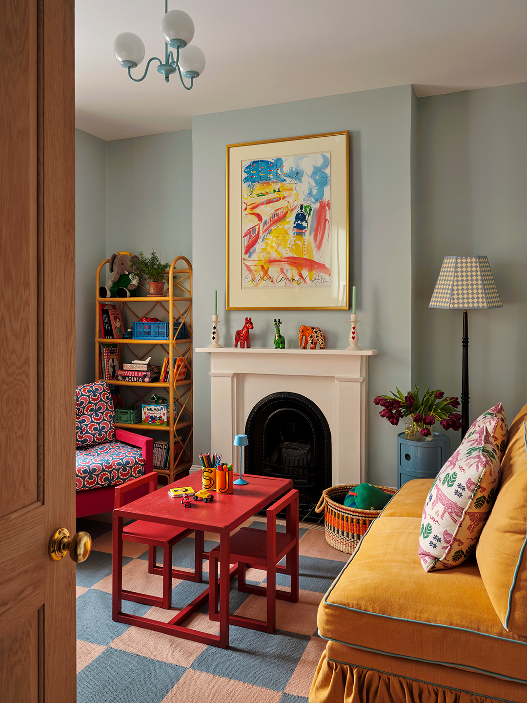 living room with small red table and chairs between sofa
