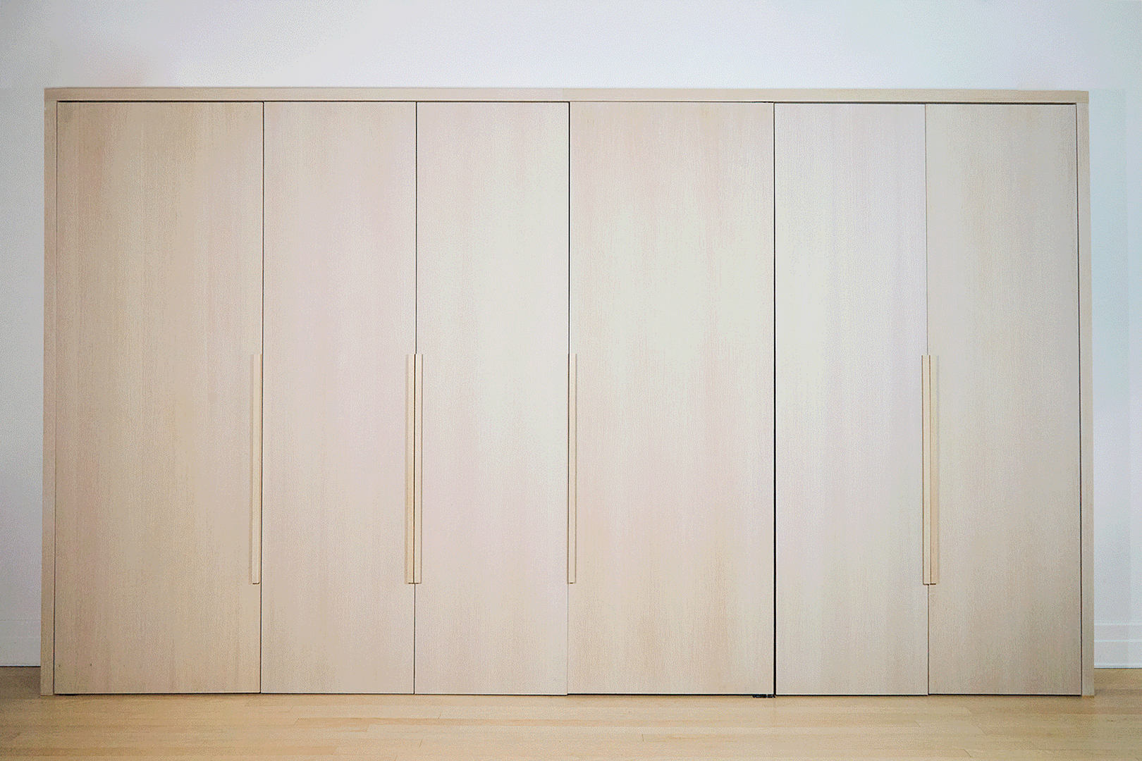 gif of cabinet wall with desks hidden inside