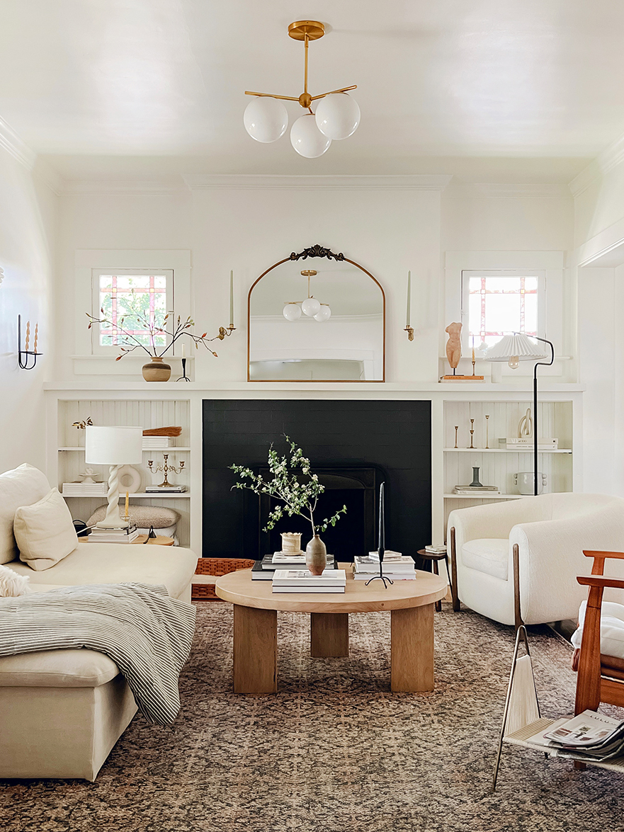 gilded mirror above living room fireplace