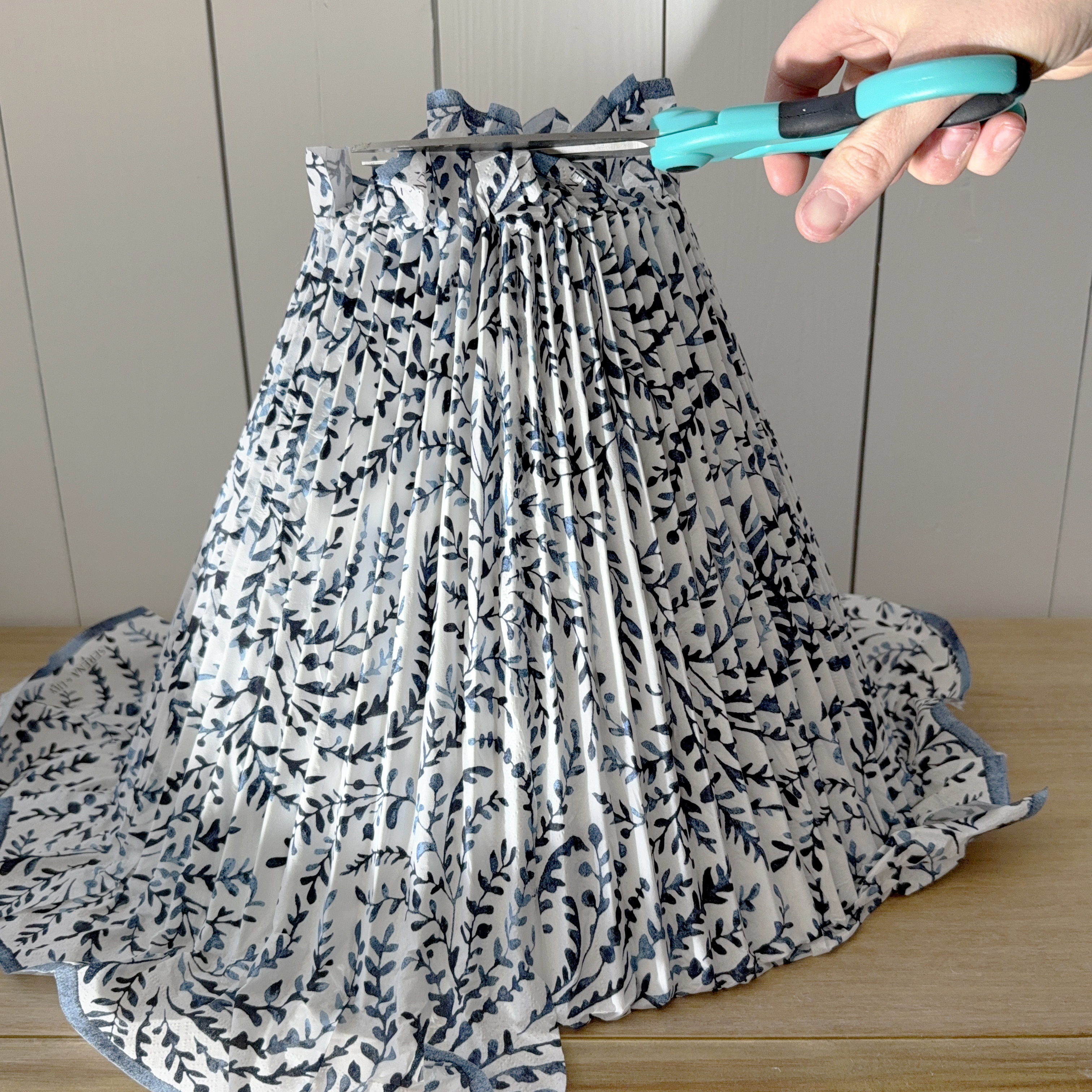 trimming excess fabric on a pleated lampshade