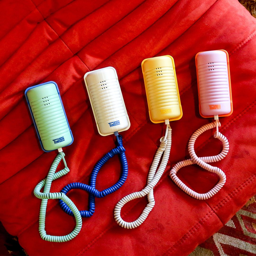 four colorful landline telephones