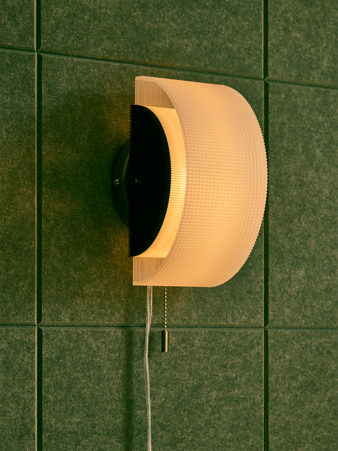 illuminated curved sconce with green background