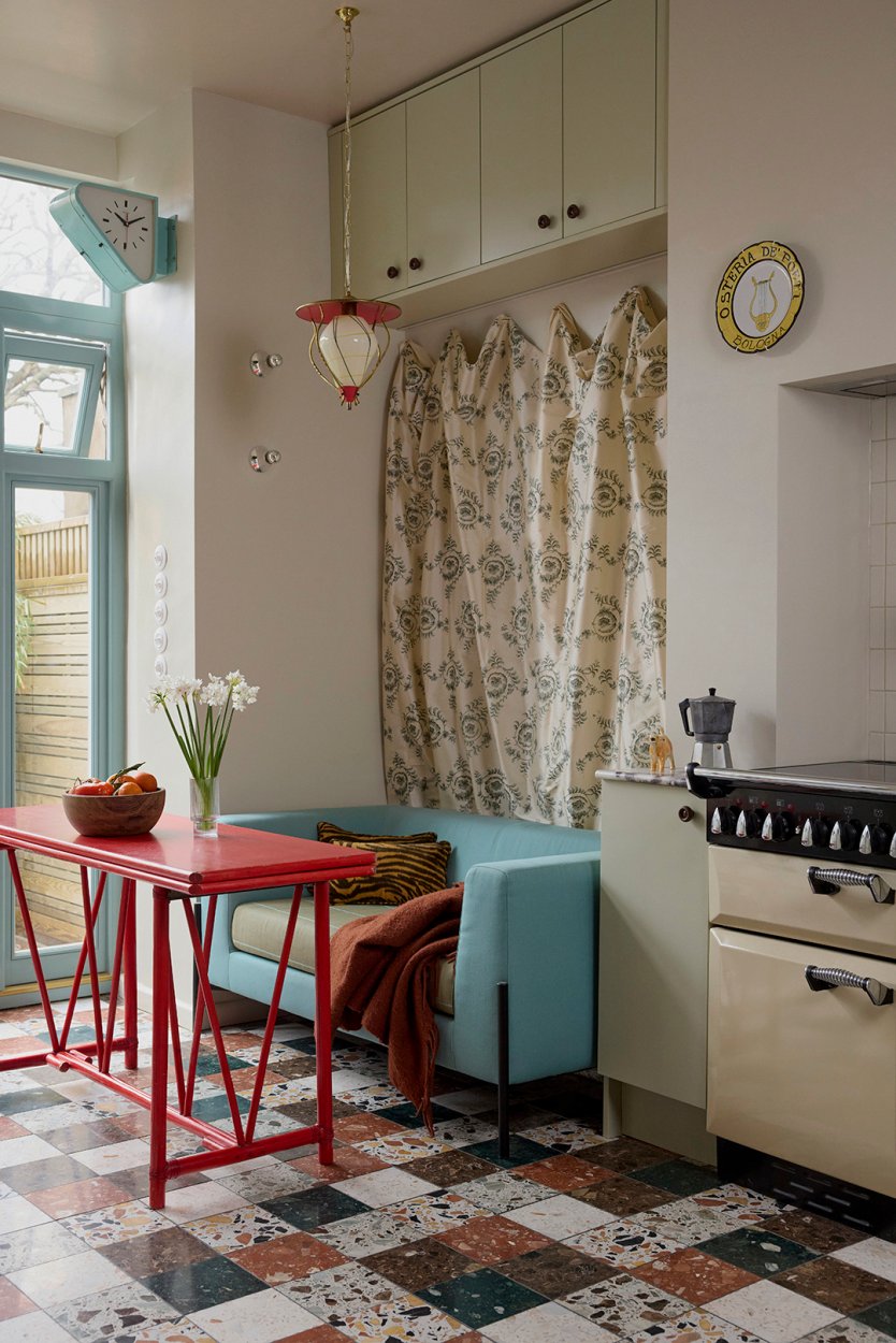 kitchen with blue upholstered sofa and red table