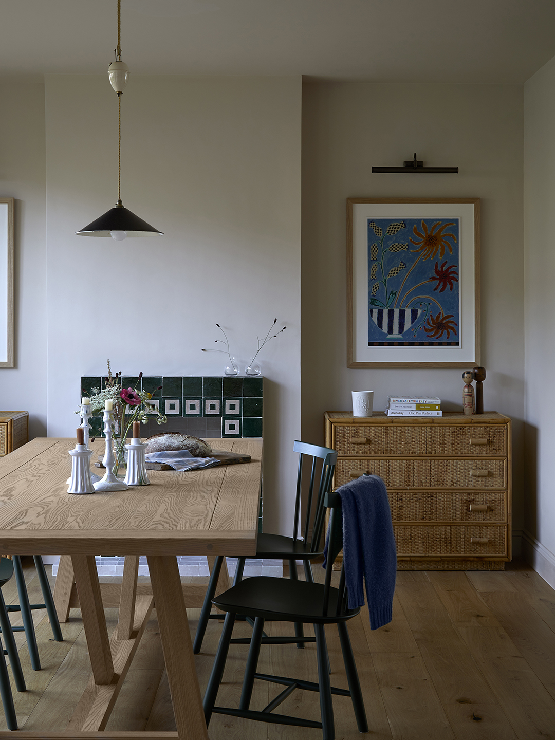 dining room with wood table, dresser, and tiled fireplace