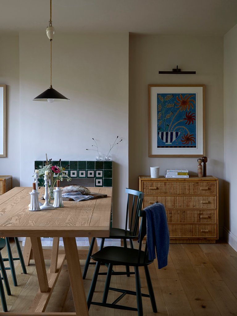 dining room with wood table, dresser, and tiled fireplace