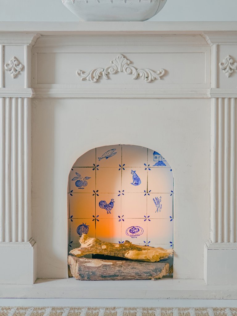 white fireplace mantel with Delft tile background