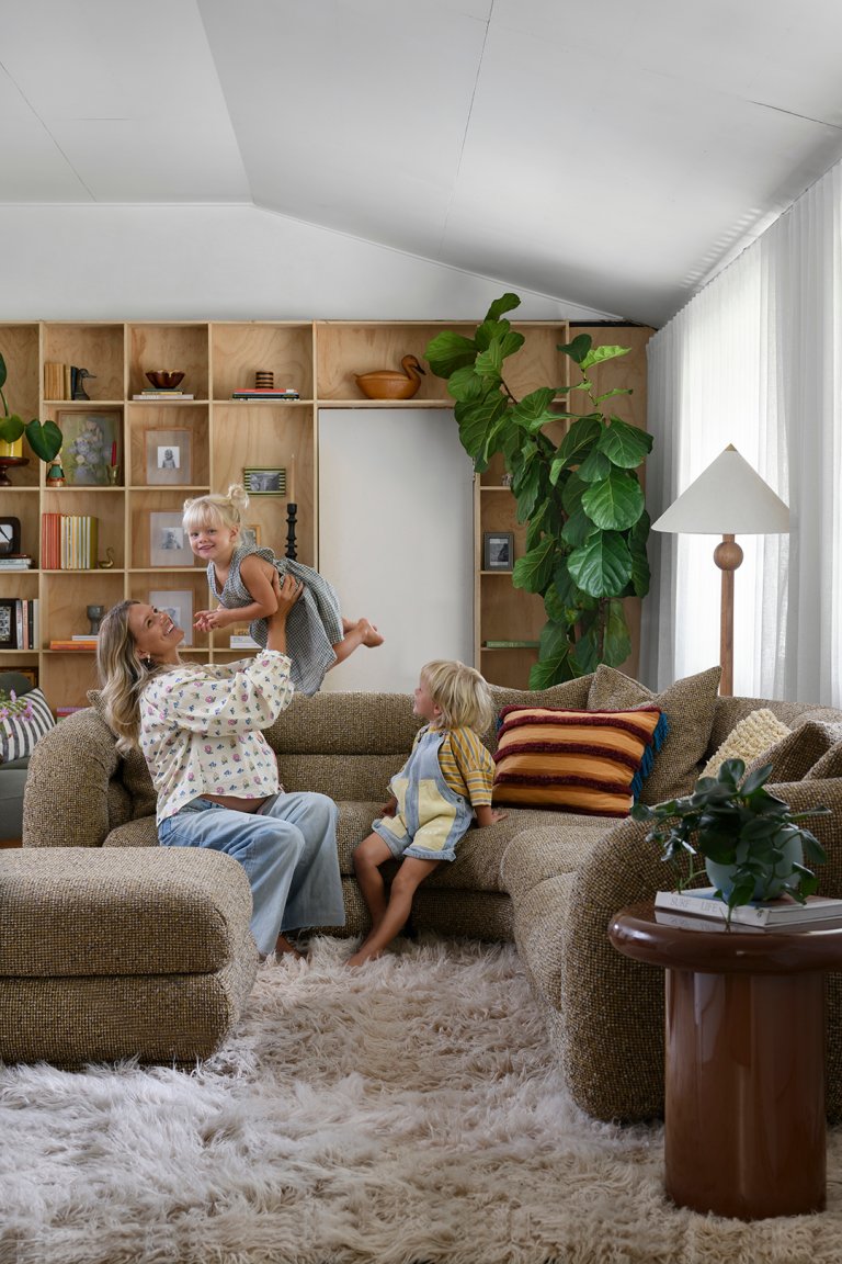 family in a living room with plywood shelves
