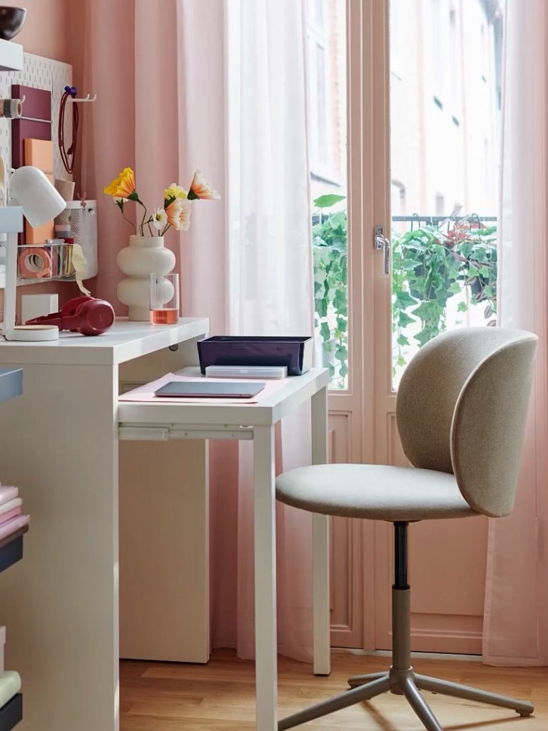 side angle of white pull-out desk by IKEA