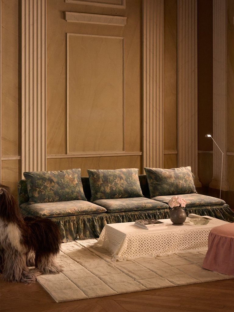 three-seater sofa with white rug and white table cloth over coffee table