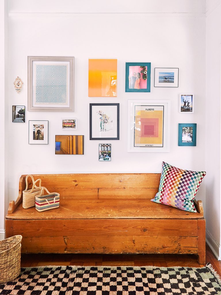wood bench with gallery wall