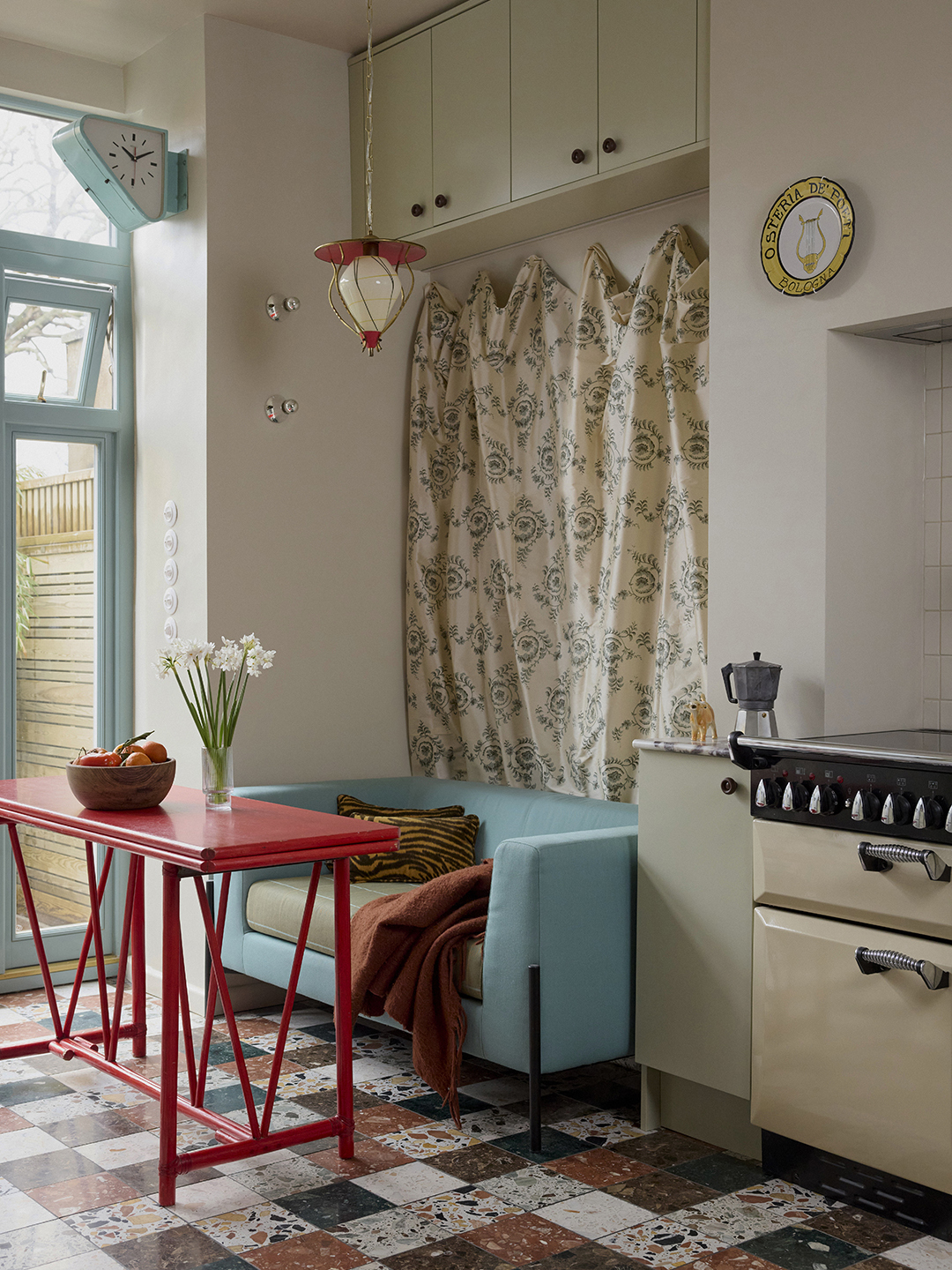 kitchen with blue couch and red table