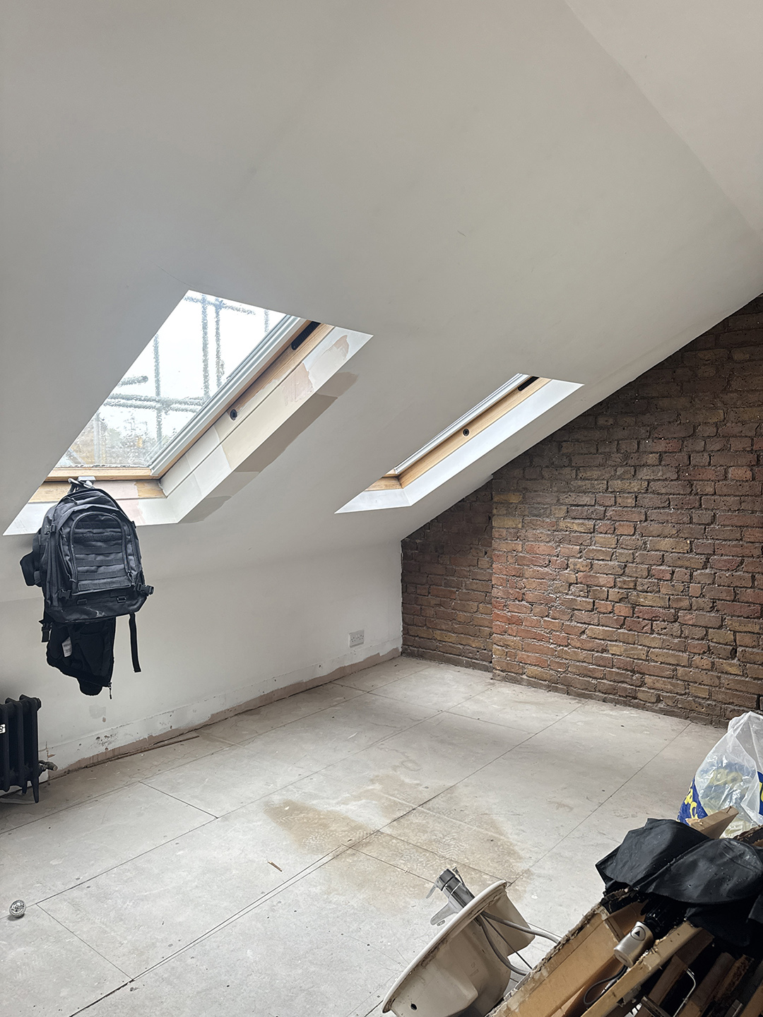 room with angled ceiling and skylights