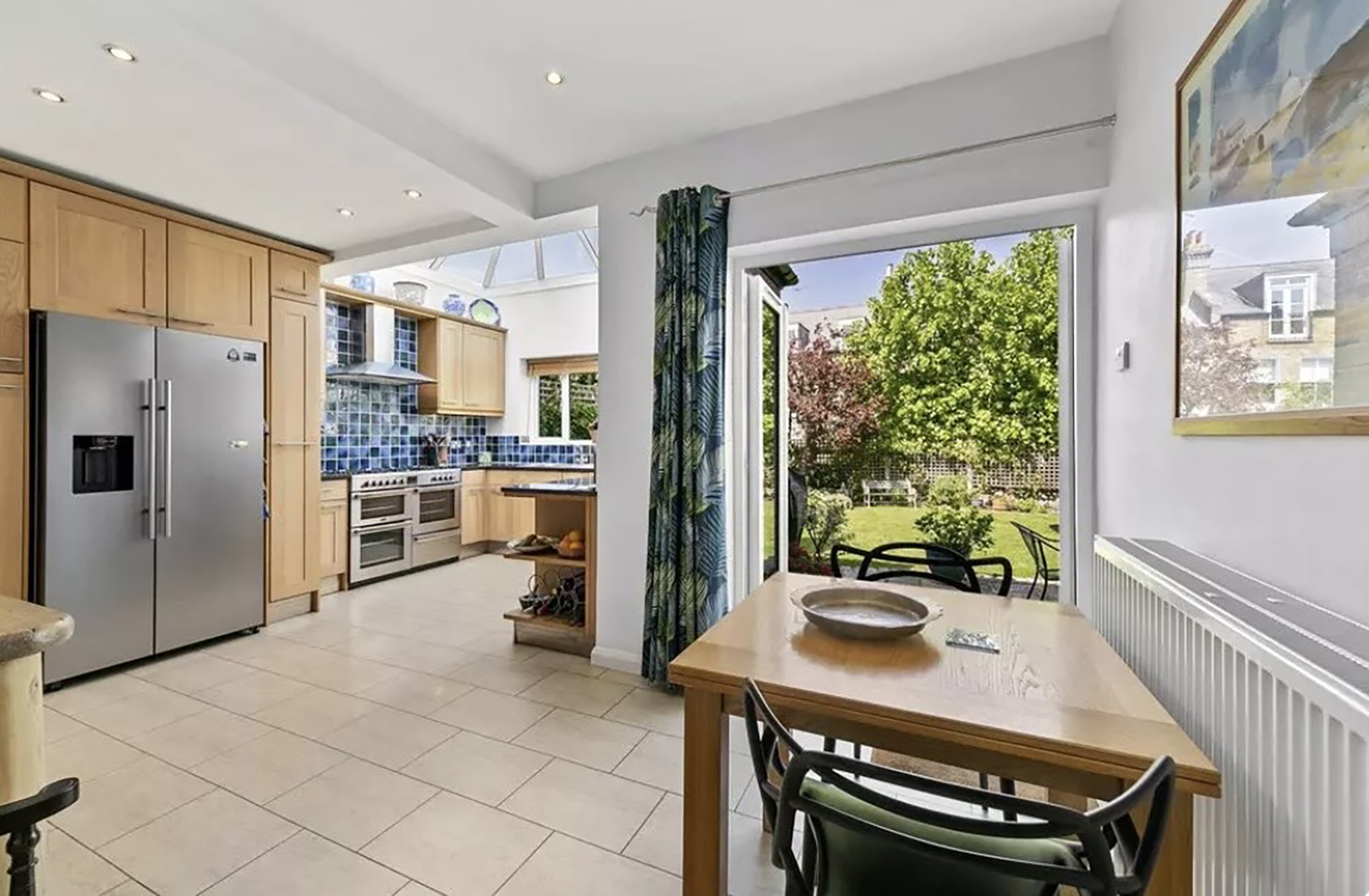 kitchen and dining nook with white walls and a view of garden