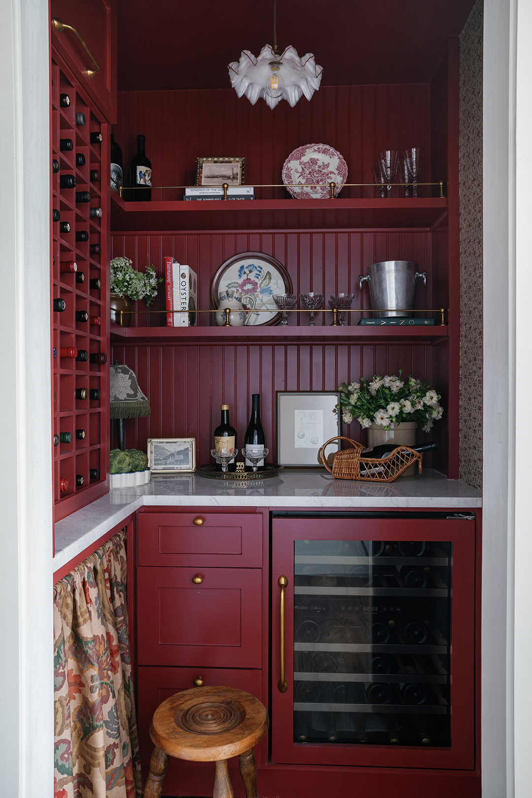 wine closet with red walls and wine fridge