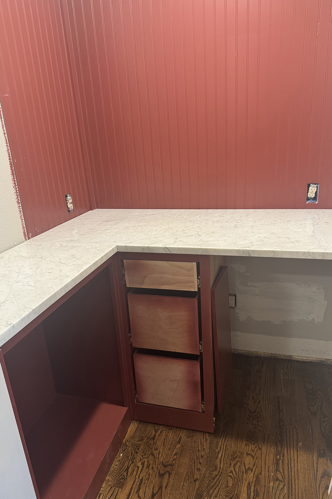 closet with red walls and marble counter