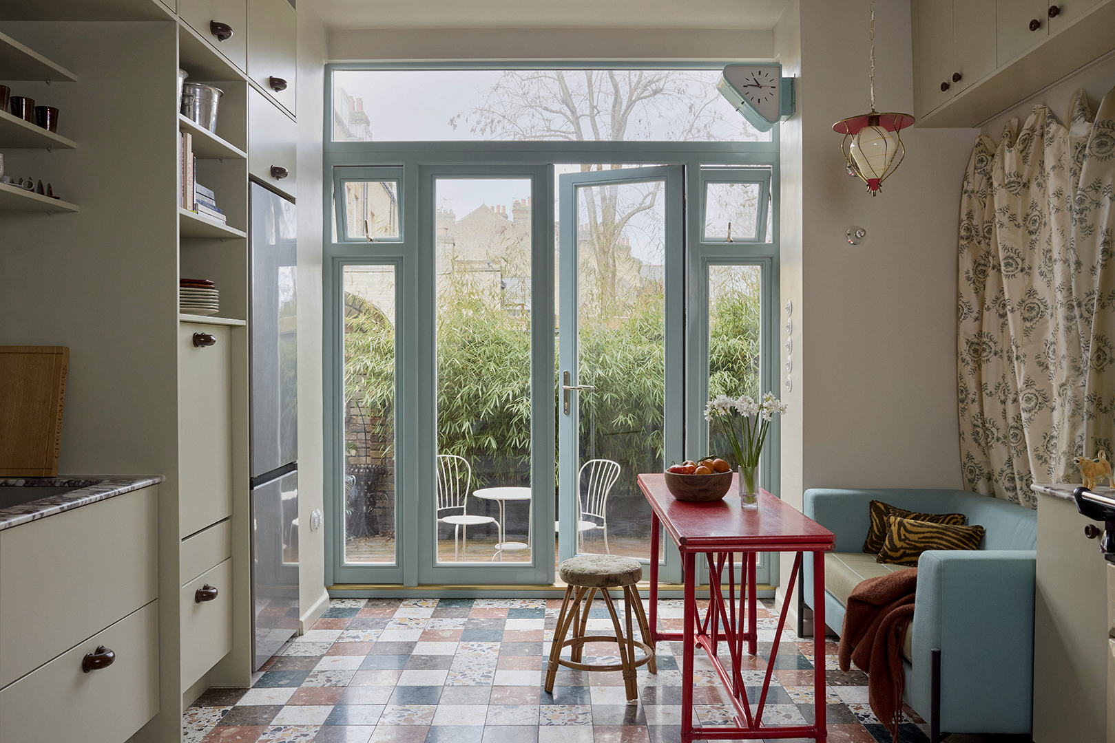 bright kitchen with blue French doors leading to a garden