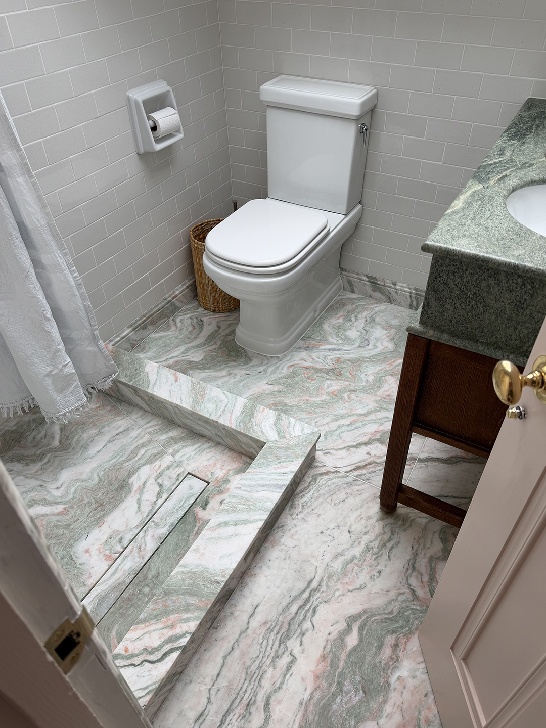 pink and green marble floor in bathroom