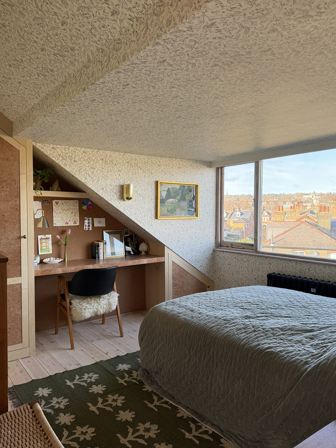 room with wallpapered ceiling and wall and built in desk nook