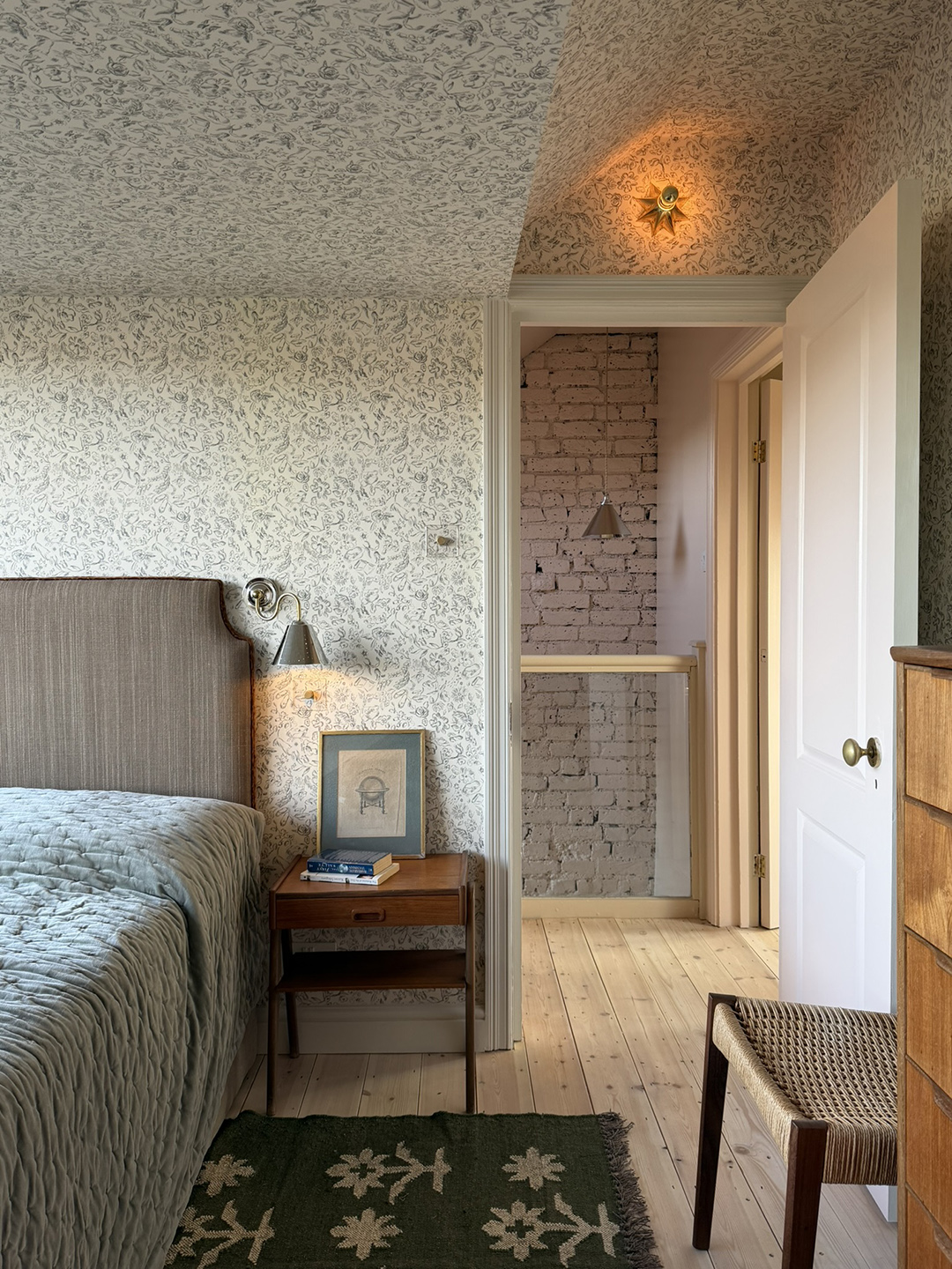 guest room with wallpapered ceiling and walls