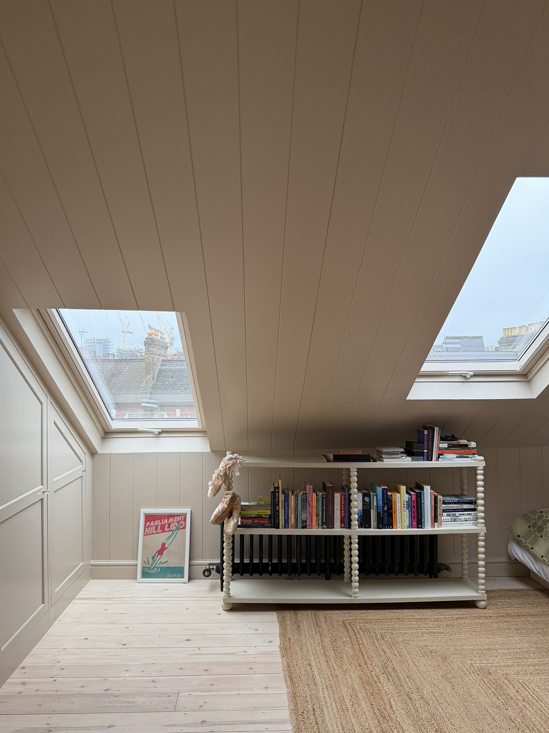room with angled ceiling and low bookshelf
