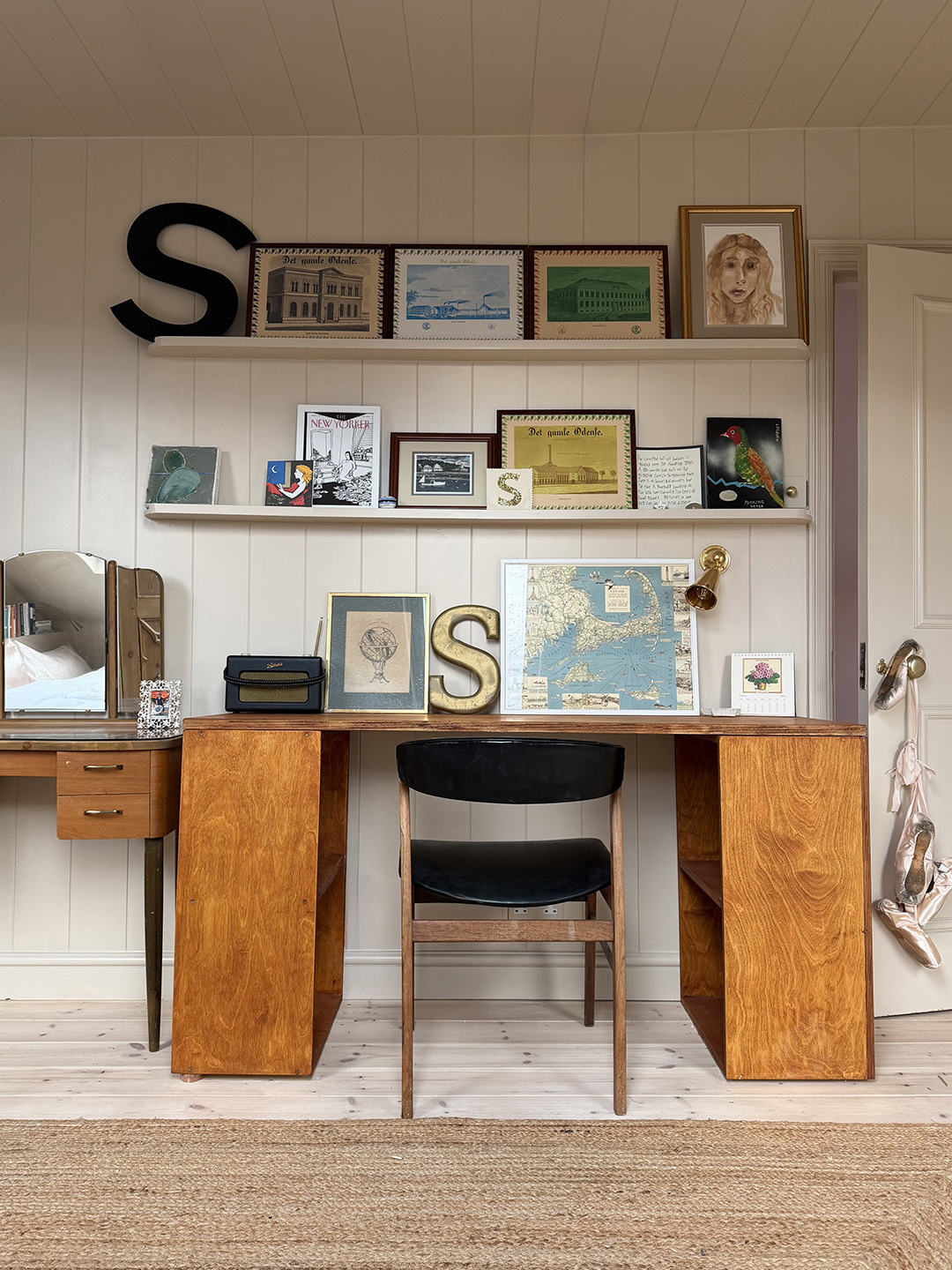 room with open shelving and wood desk