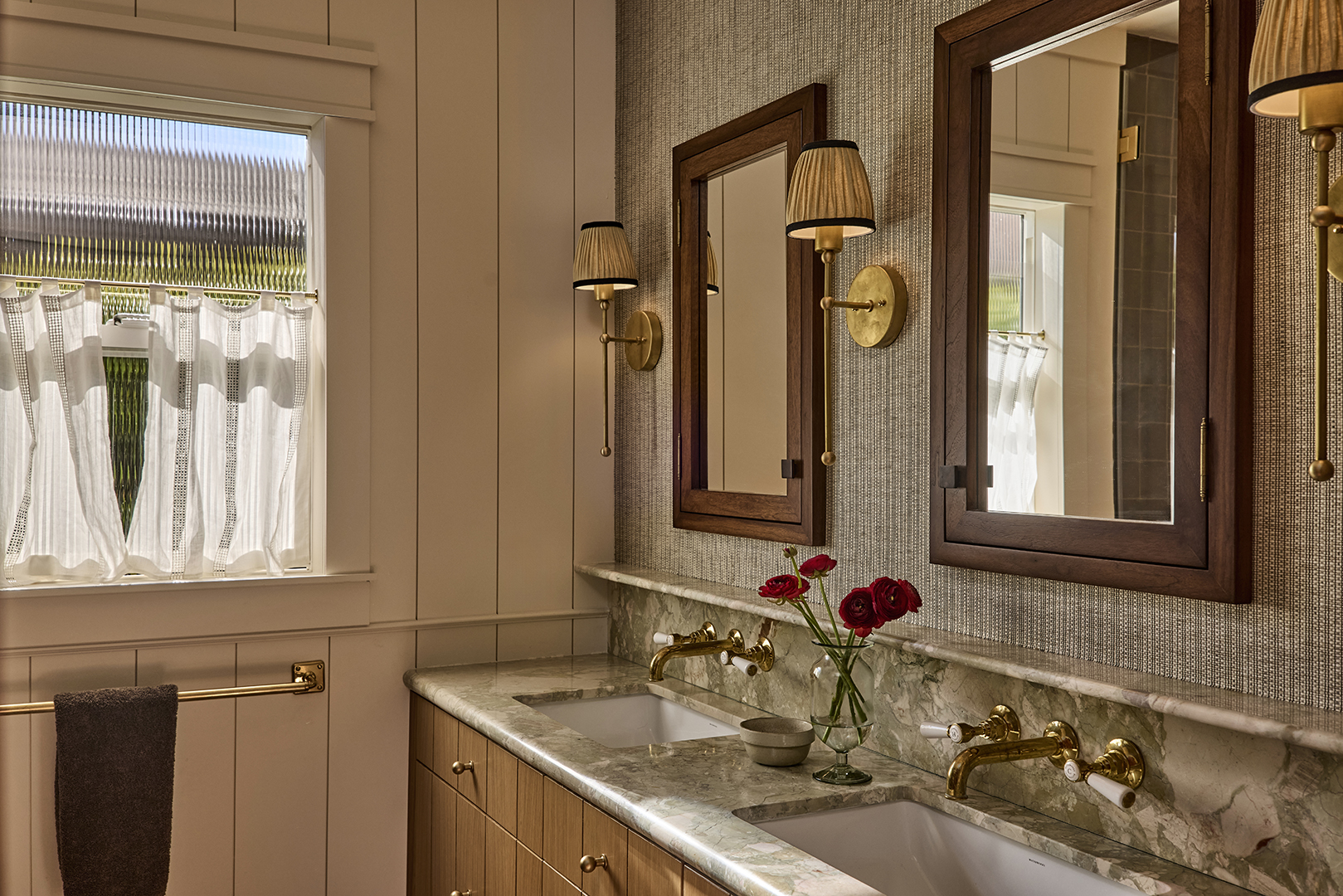 bathroom with wood medicine cabinets and sconces with lampshades