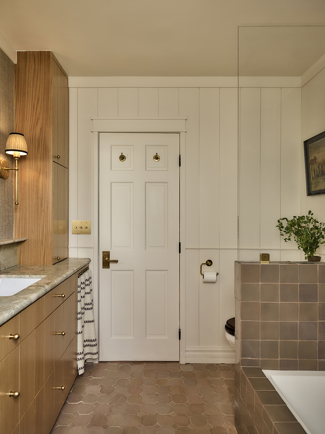 bathroom with white walls and tiled floor and shower