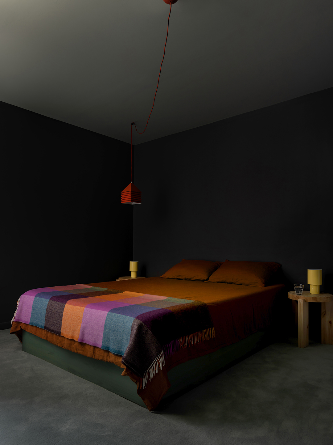 dark bedroom with bed and two bedside tables