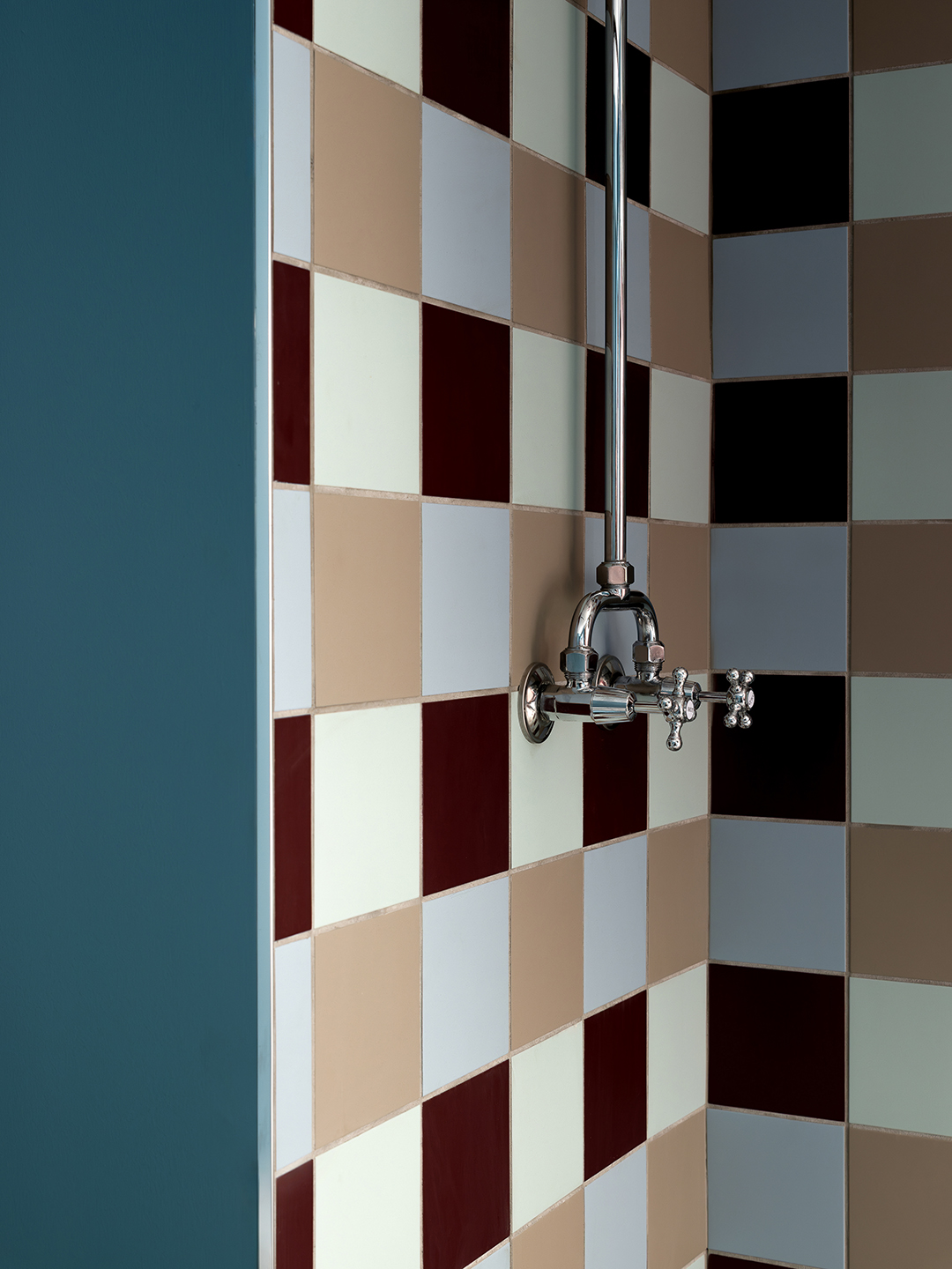 bathroom details with tiled walls and silver faucet