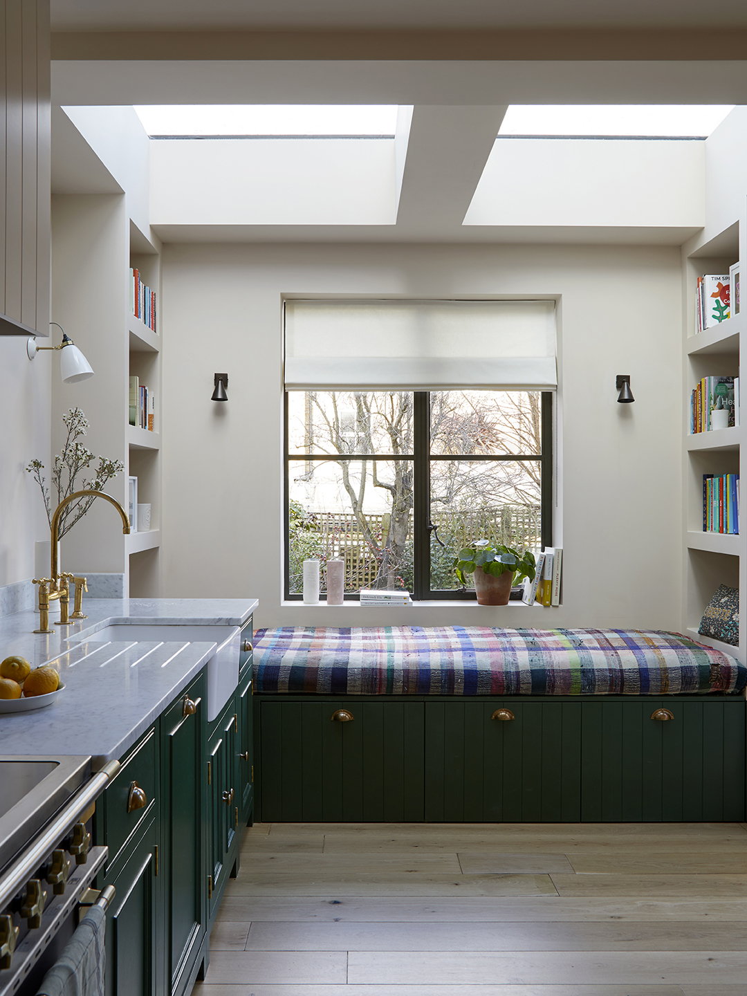 kitchen with green cabinets and plaid bench in nook