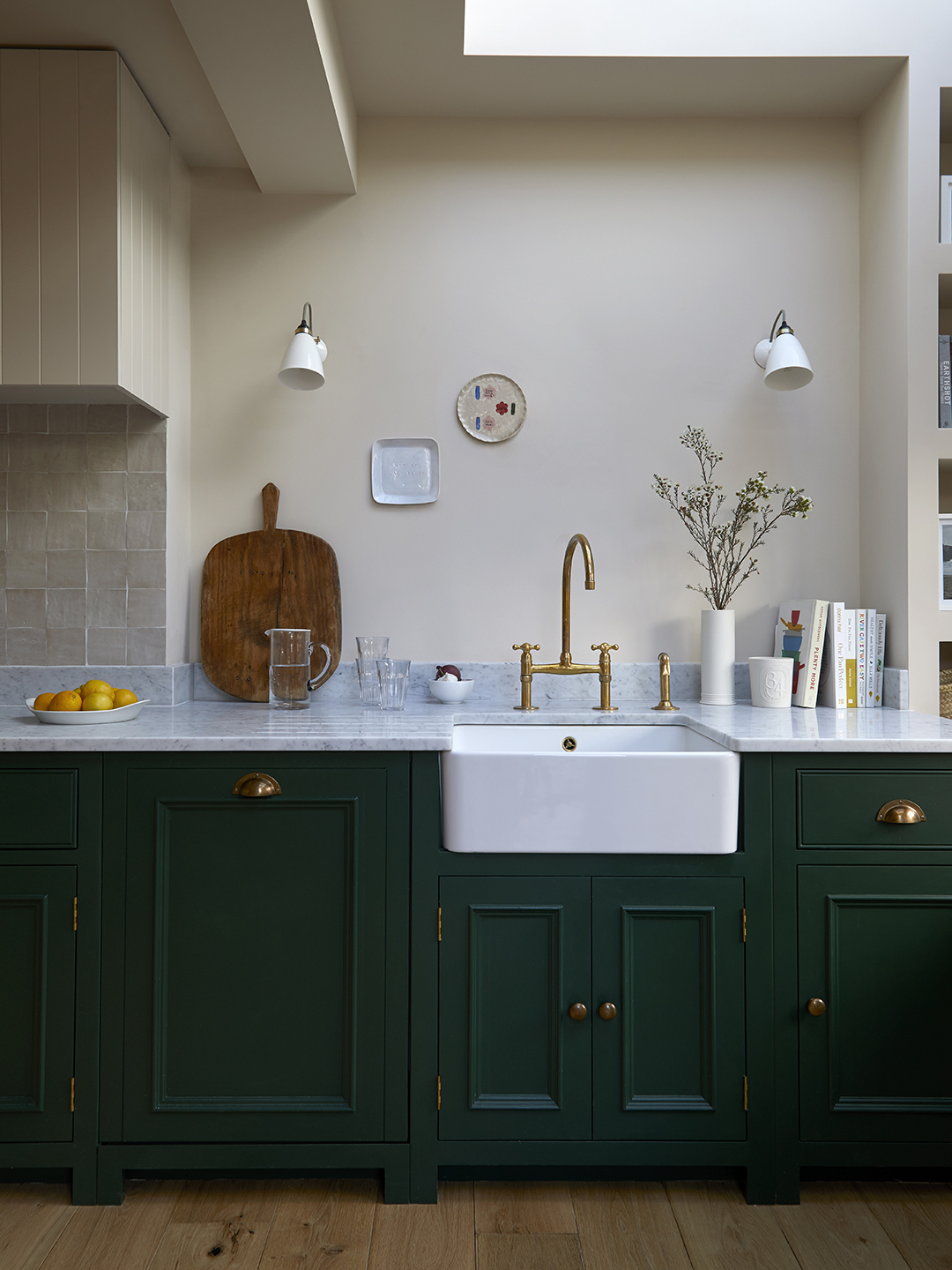kitchen with green cabinets, marble counters, and cream walls