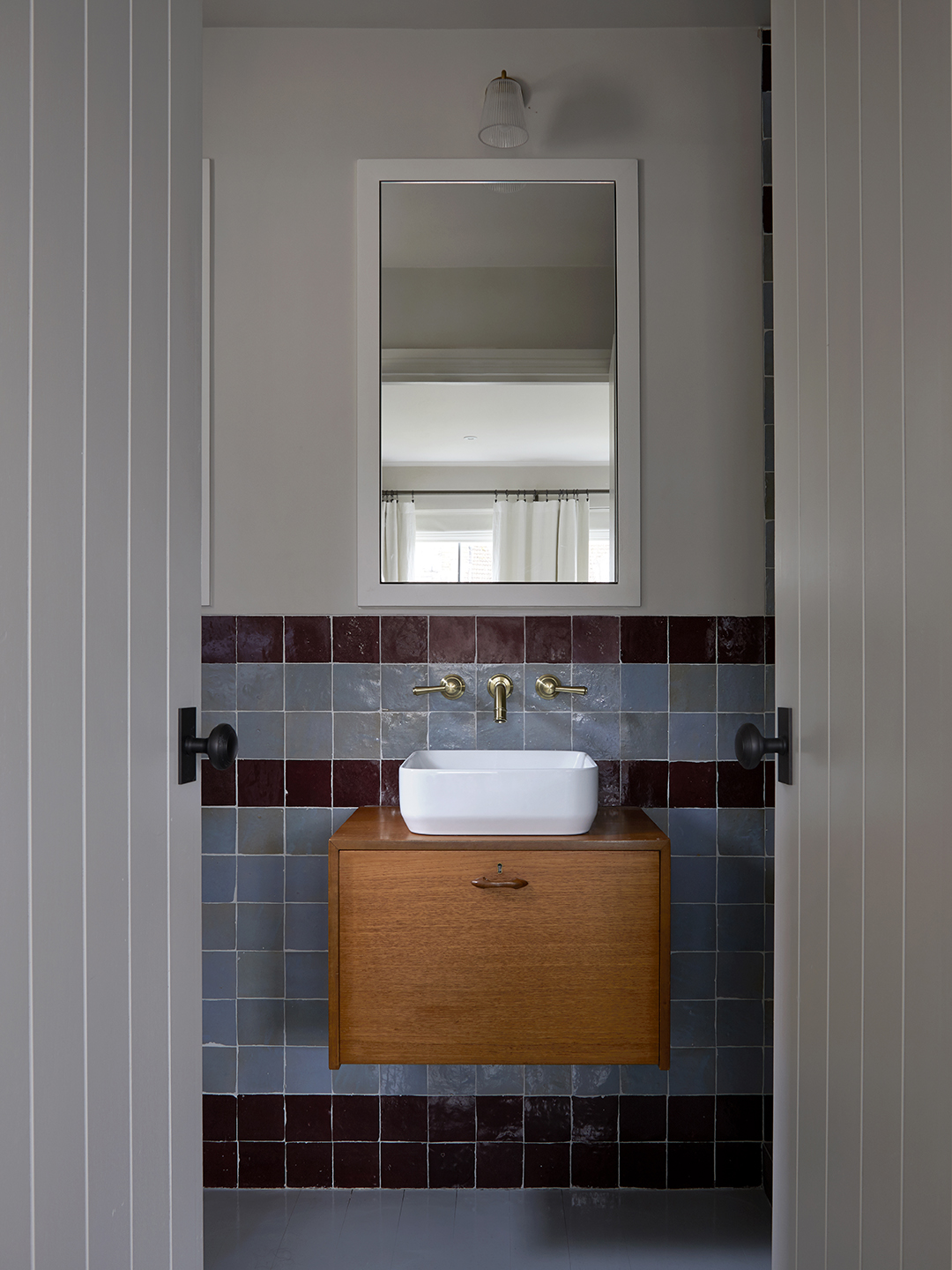 view of bathroom with wood vanity and tiled wall