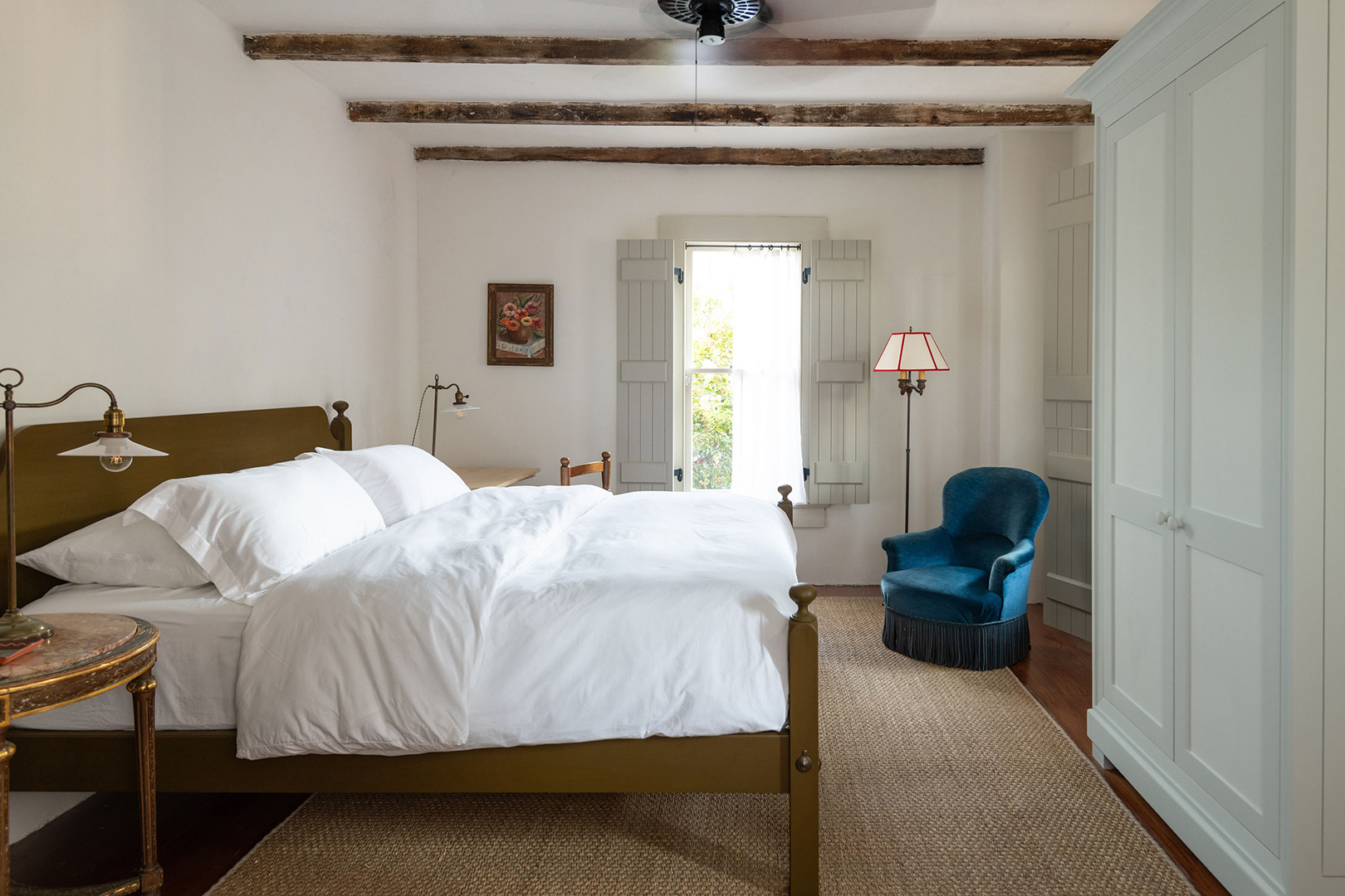 bedroom with white bedding and jute rug