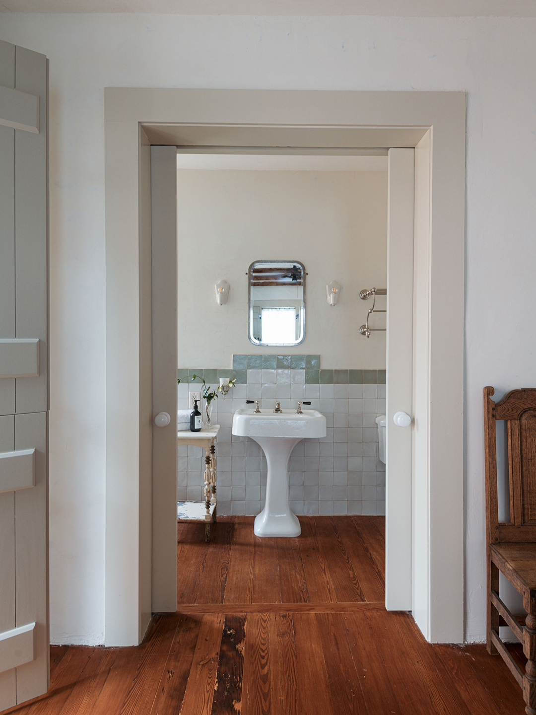bathroom with white sink and wood floors
