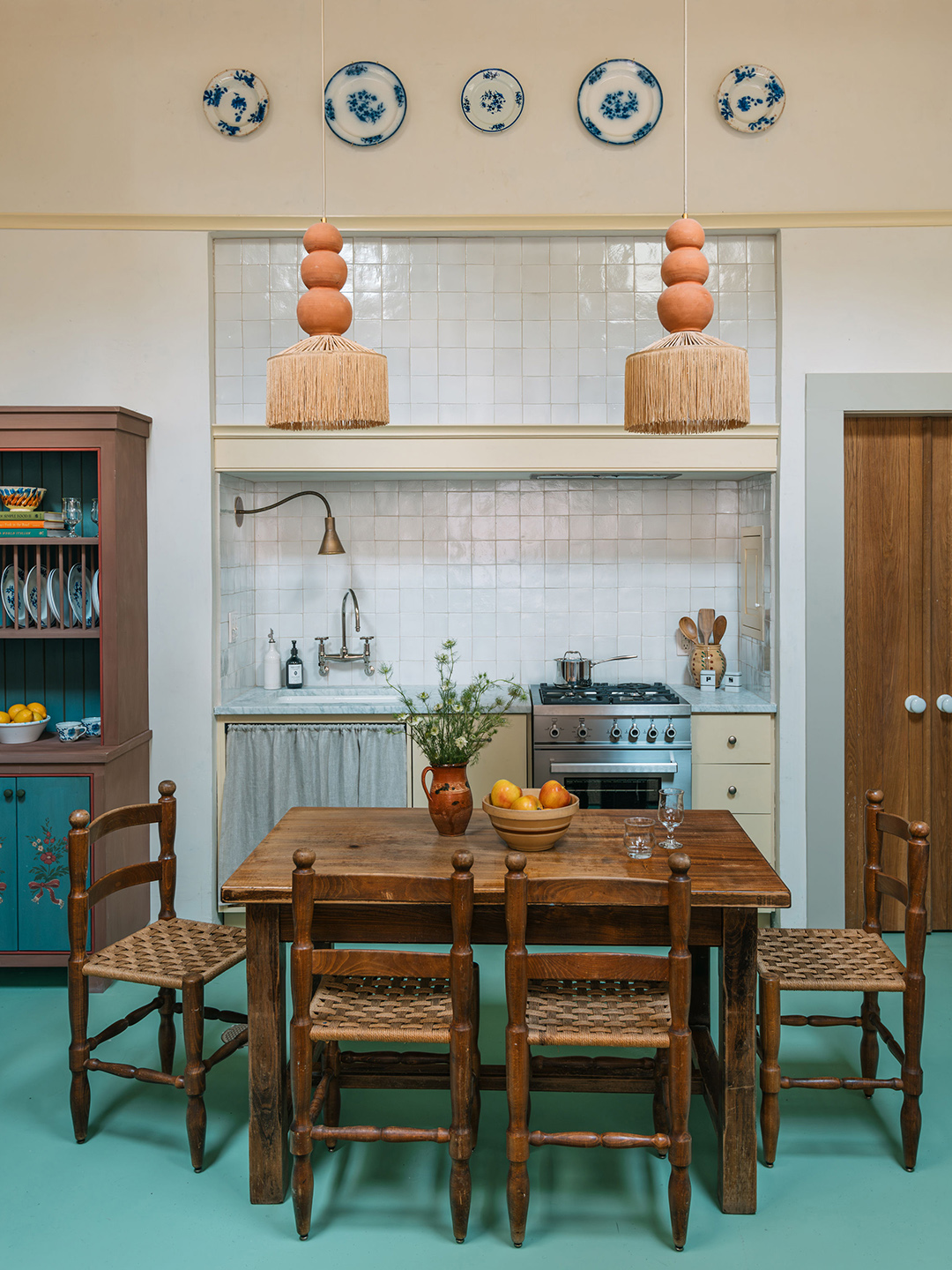 tiled kitchenette area with dining table and chairs