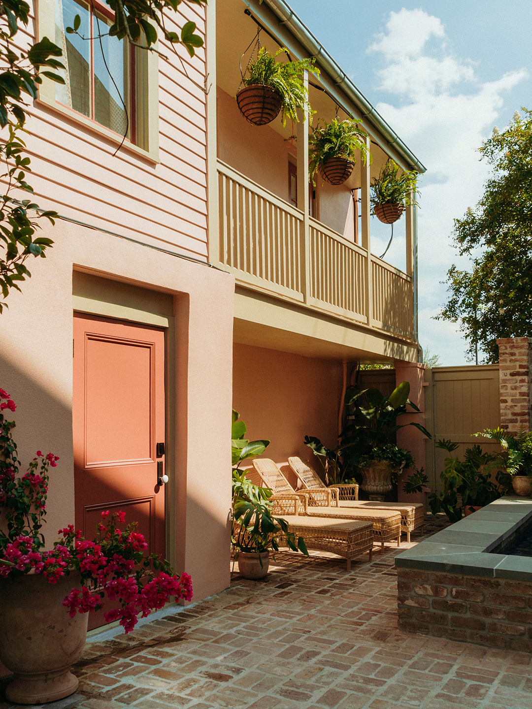 exterior of building with balcony and lounge chairs