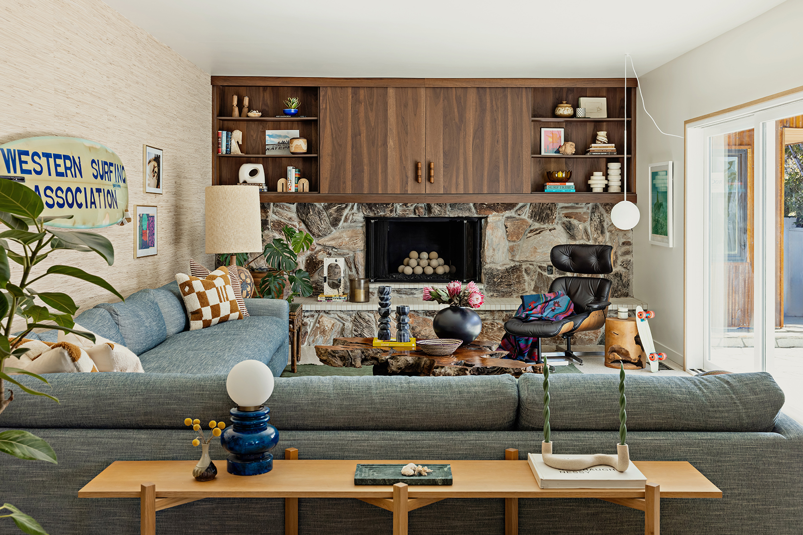living room with sectional sofa and stone fireplace