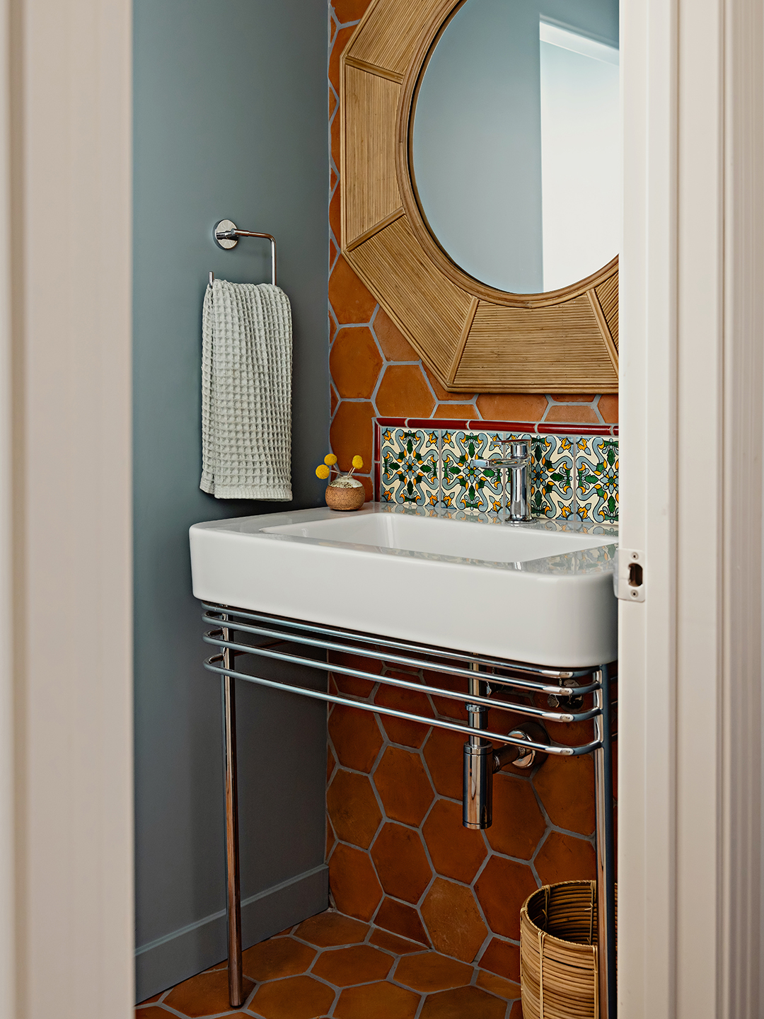 powder room with terracotta tile and white sink