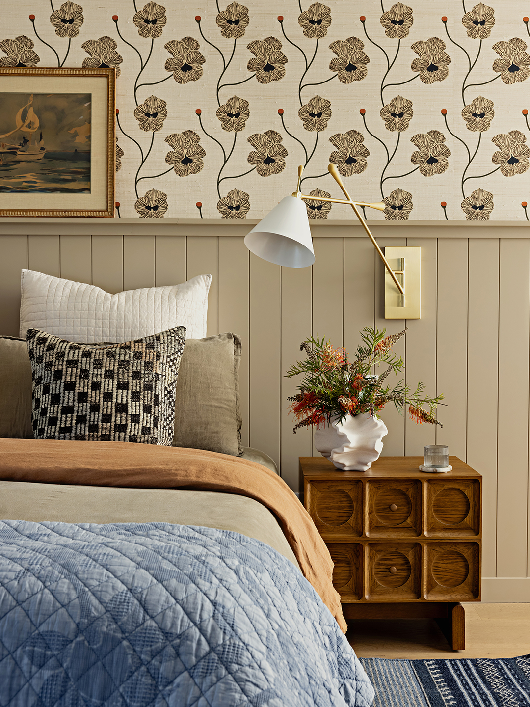 bedroom with bed, floral wallpaper, and wood side