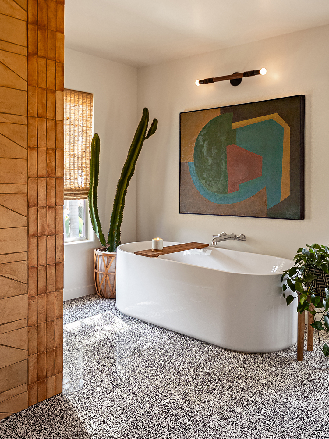 bathroom with terrazzo floor and large white tub