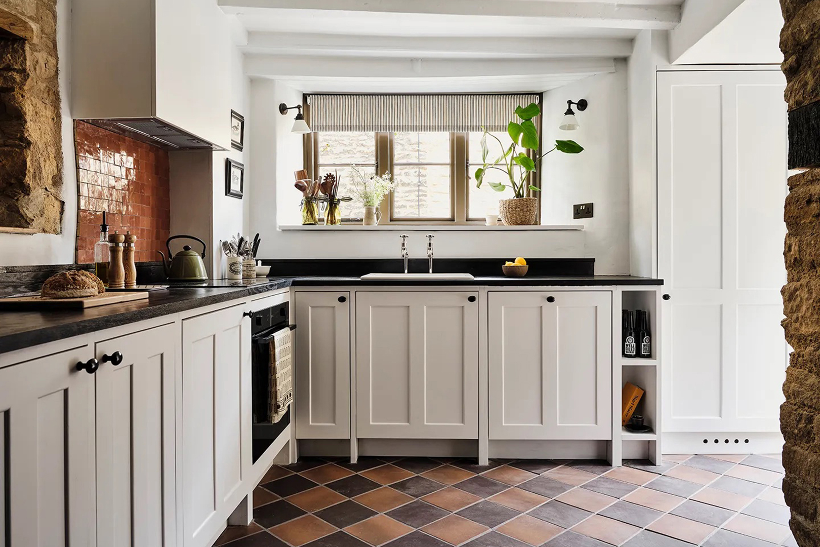 white kitchen with checkered floor and tiled backsplash