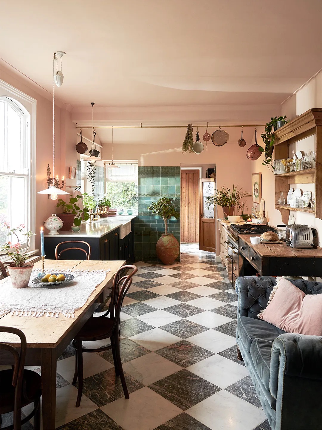 pink kitchen with checkered floors