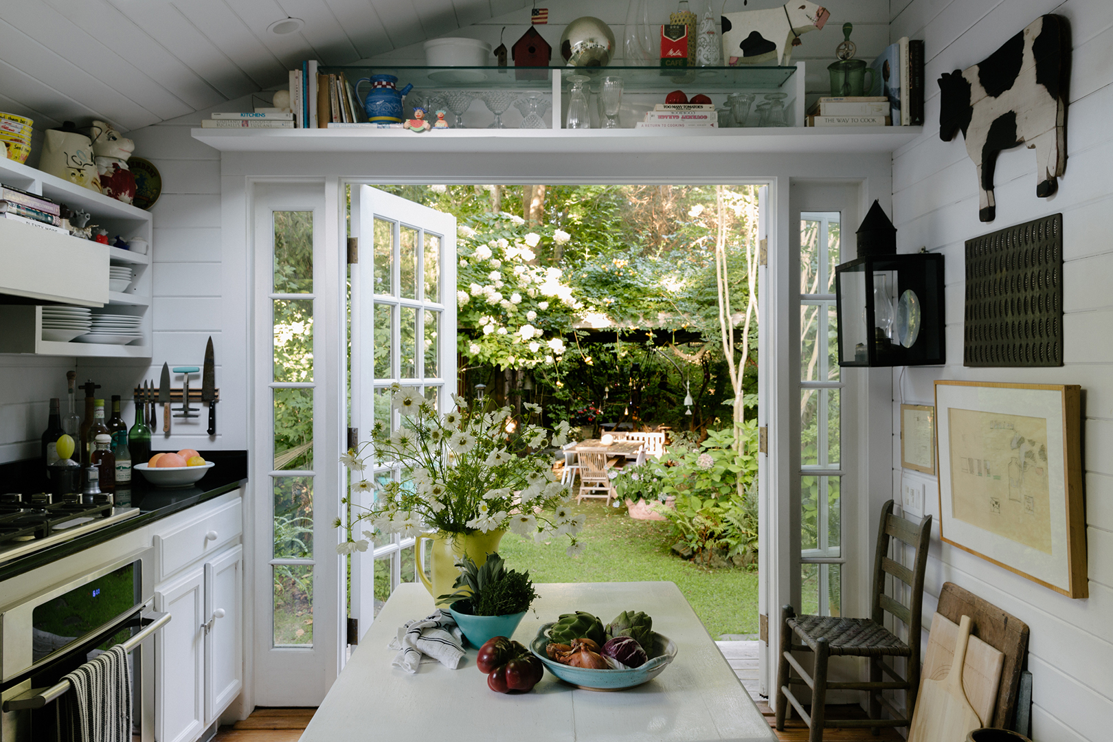 kitchen with open double doors and garden in background