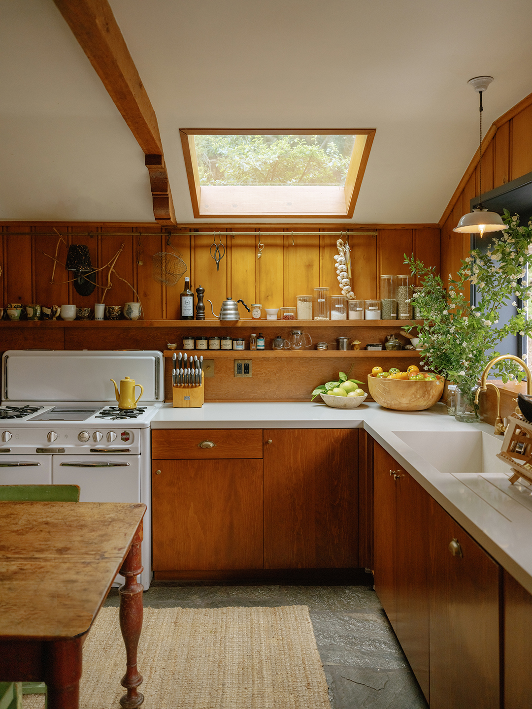 kitchen with wood walls and cupboards and a white stove