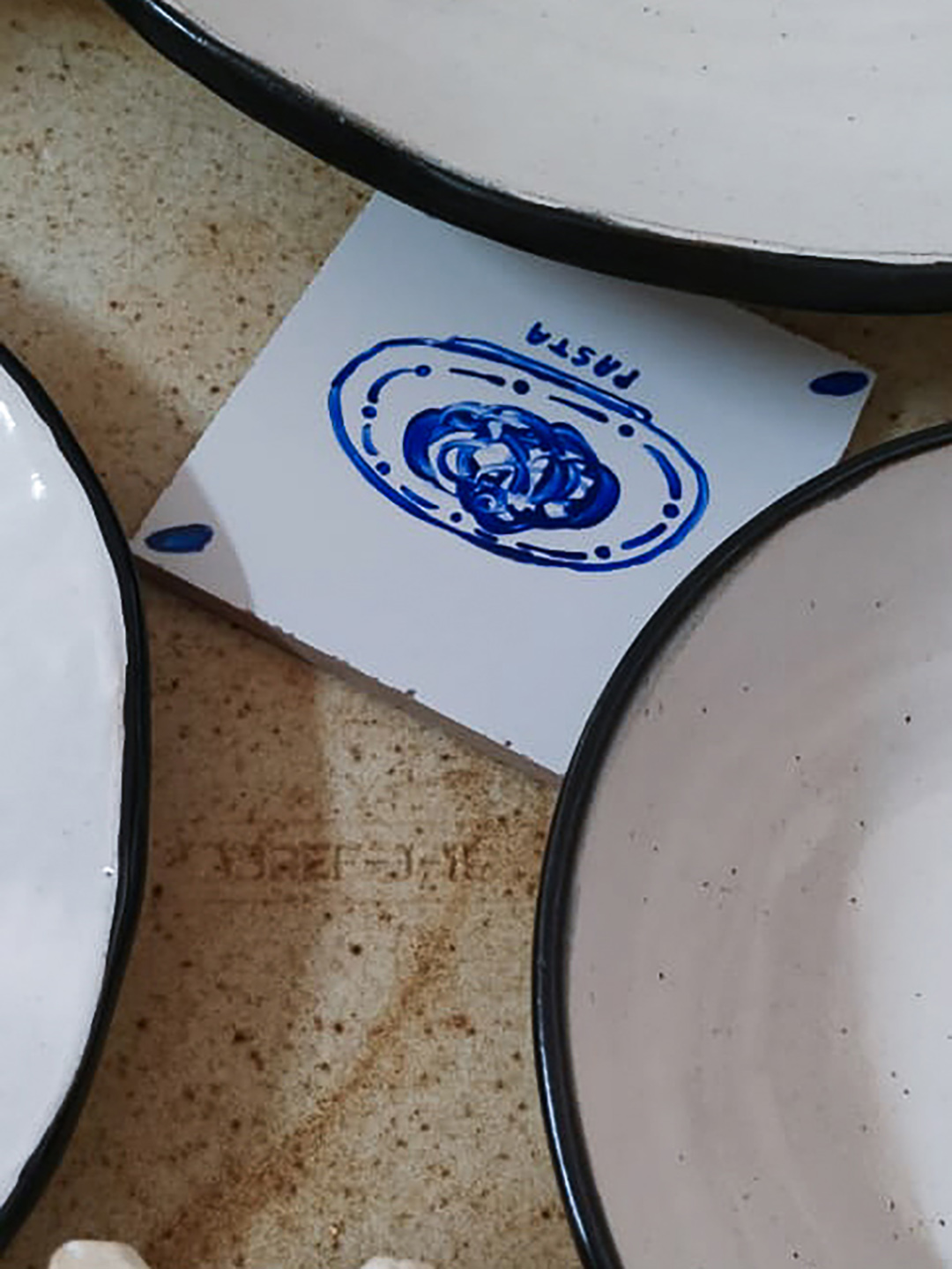 blue-and-white tile under some plates