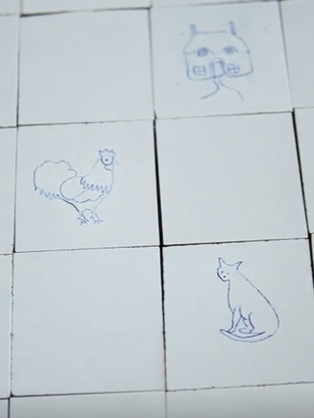 white tiles some of which have faint blue paintings on them