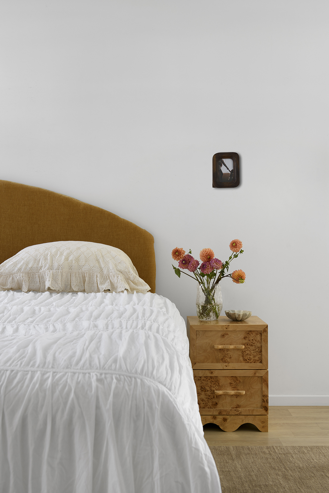 bedroom with wooden headboard and nightstand
